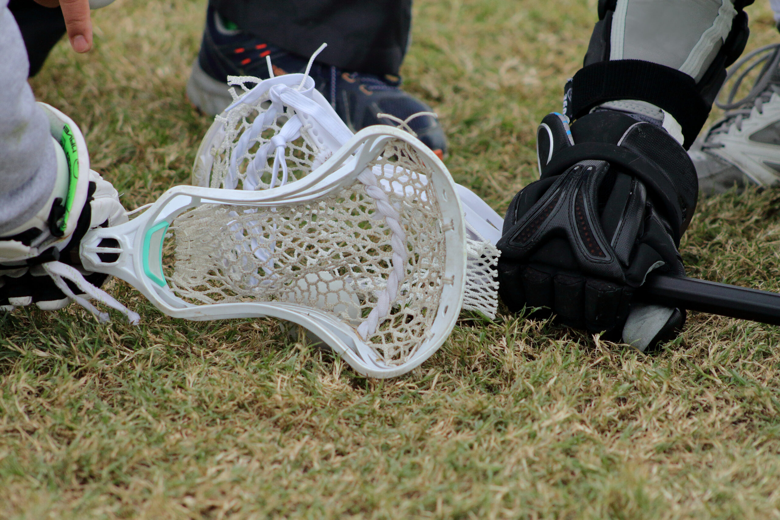 Close up picture ofheads of lacrosse sticks during face-in stage.